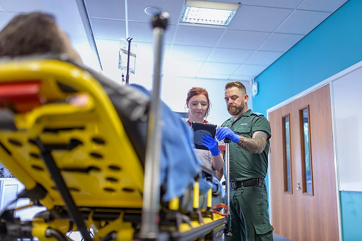 A couple using technology, tab in there hands to accessing the patient condition