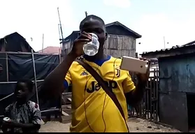 Man recording a video having Amanzi clean water
