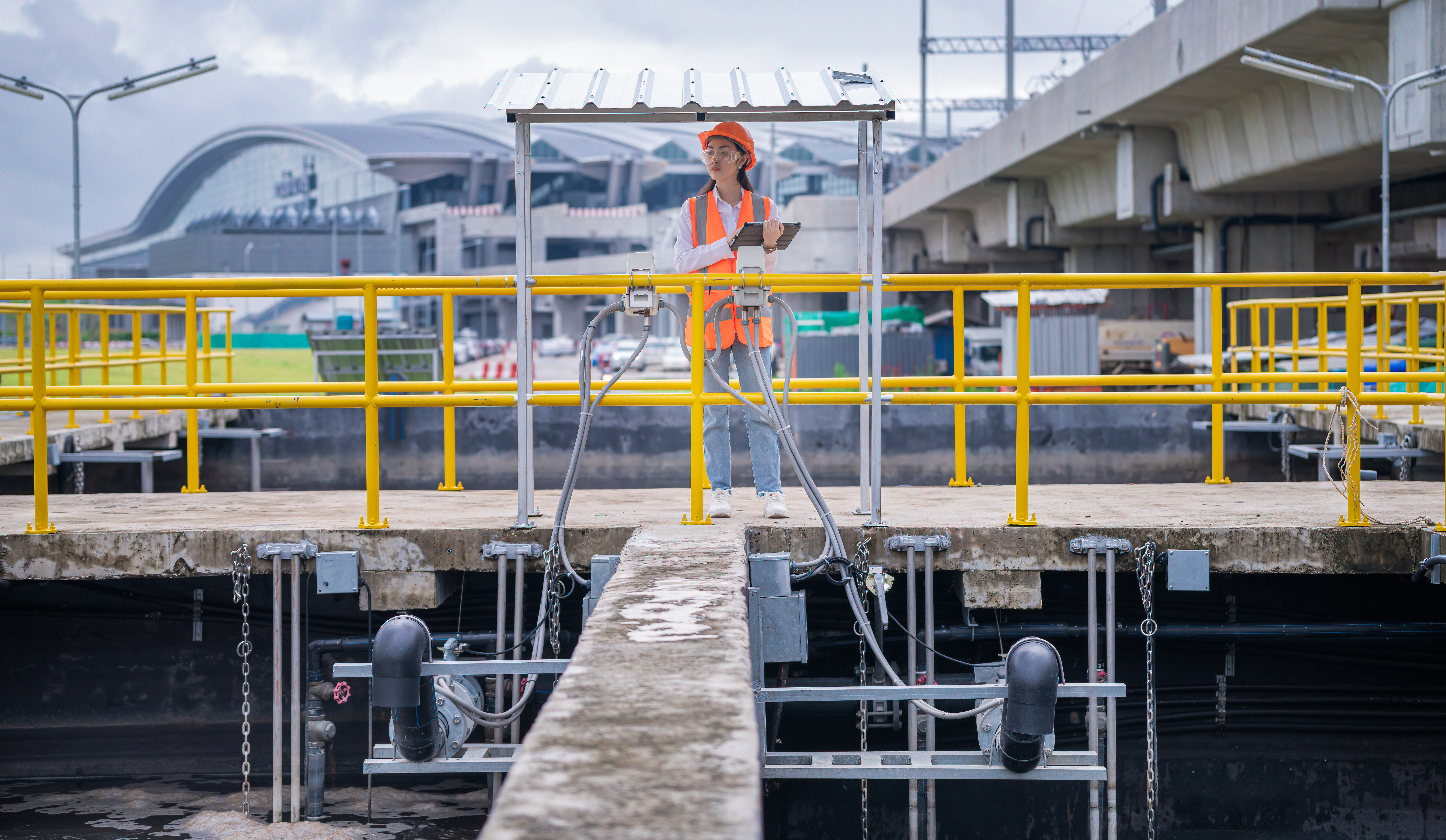 engineer take water from wastewater treatment pond