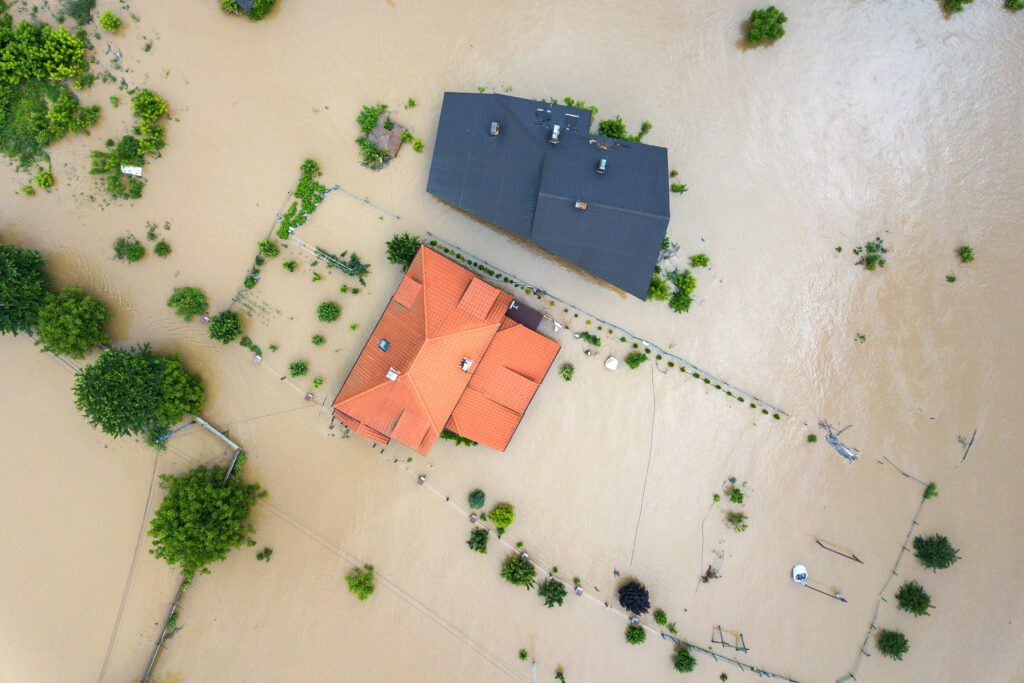 Aerial view of flooded houses with dirty water