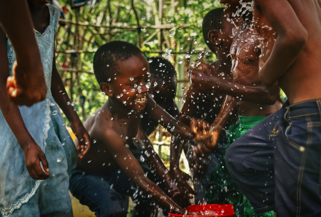 Kids joyfully playing with water outdoors